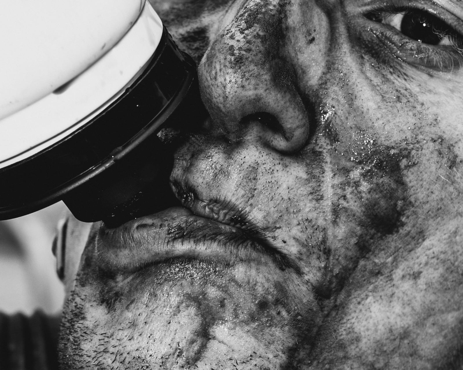 Rider’s face covered in mud after a race, close-up